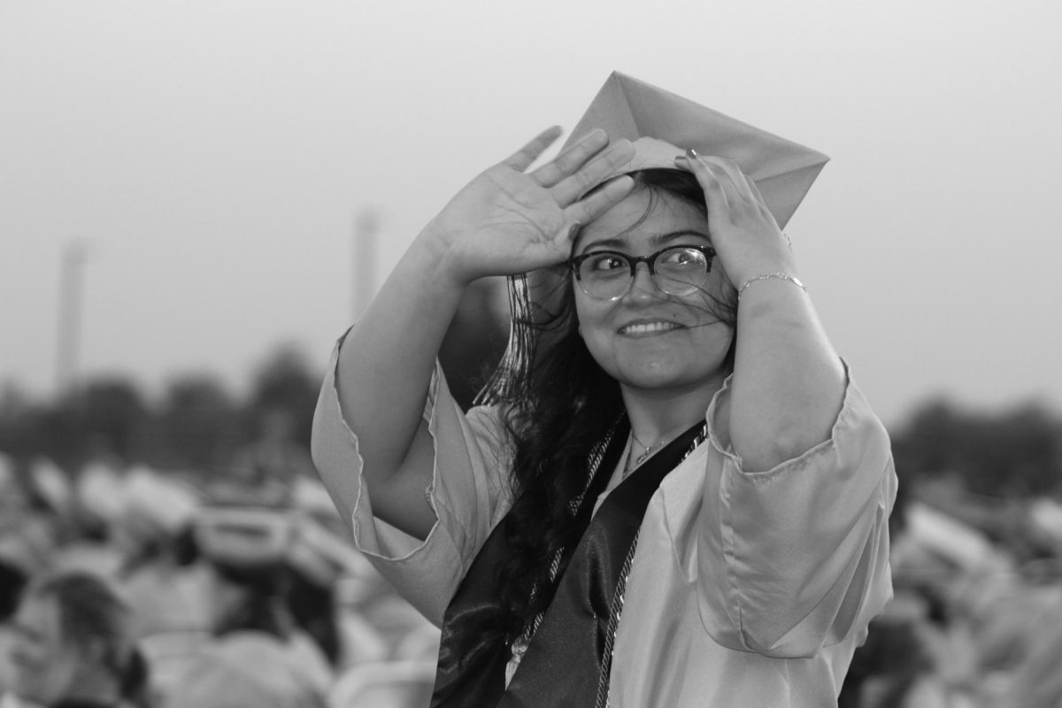 Senior Melanie Perez Jaramillo is seen waving at a friend out of frame.