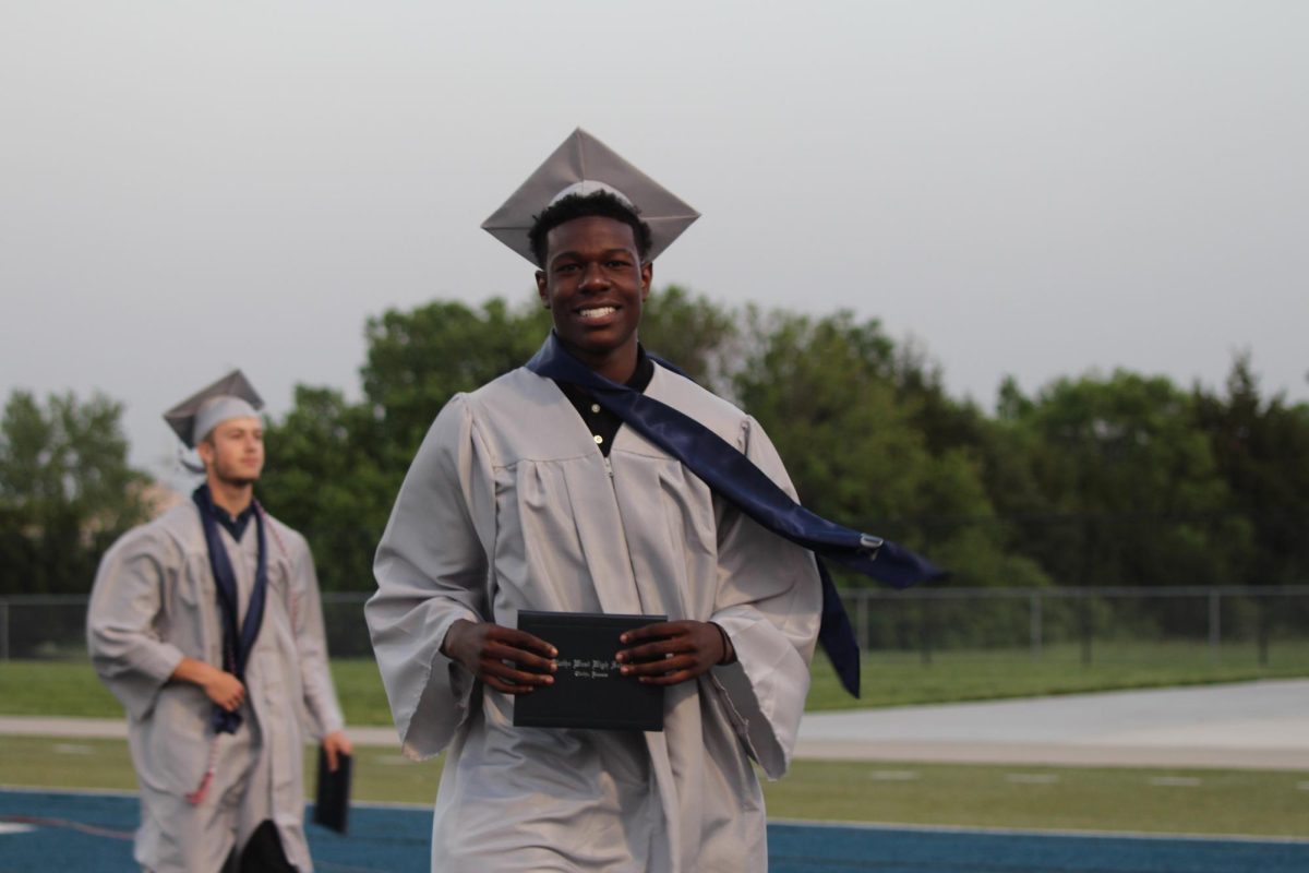 Senior Simba Mundava smiles at the camera after receiving his diploma.