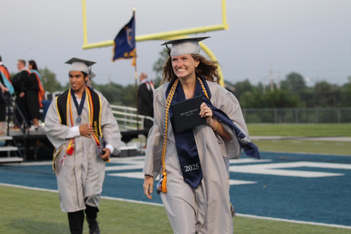 Senior Hannah Rahe smiles at teachers after receiving her diploma.