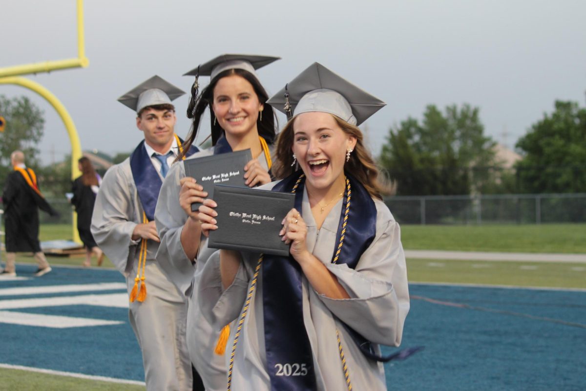 From left, seniors Caden Shepard, Nadia Searing and Reagan Seaba smiling after receiving their diplomas.