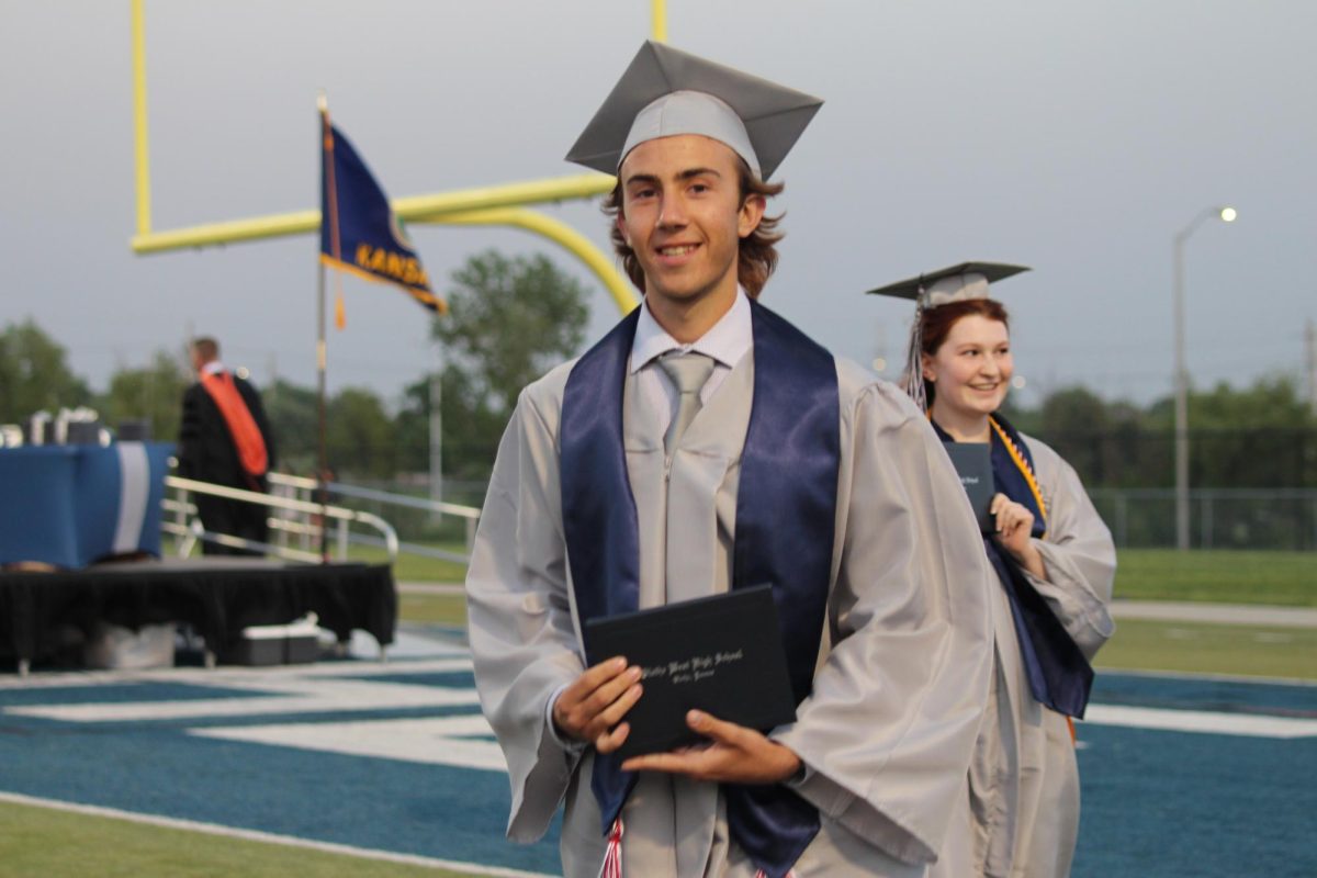 Senior Braxton Theel smiles at the camera after receiving his diploma.