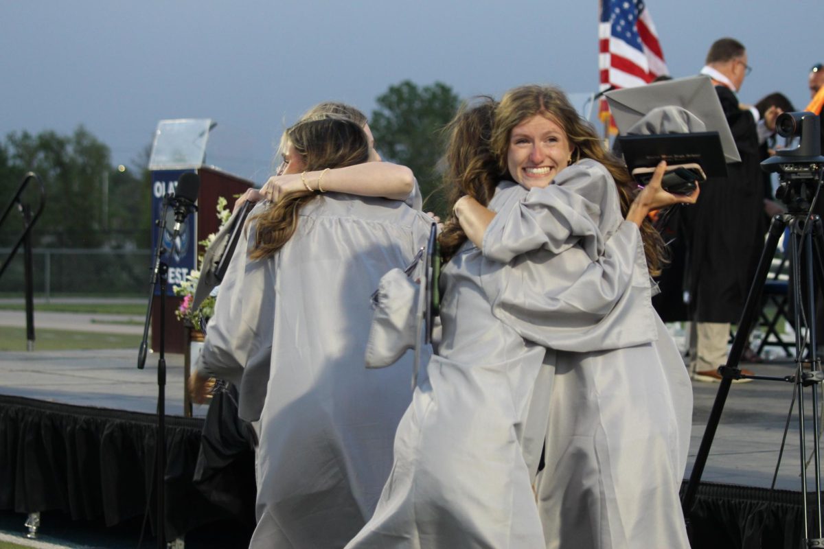 Senior Hannah Rahe hugs her friend after the graduation ceremony.