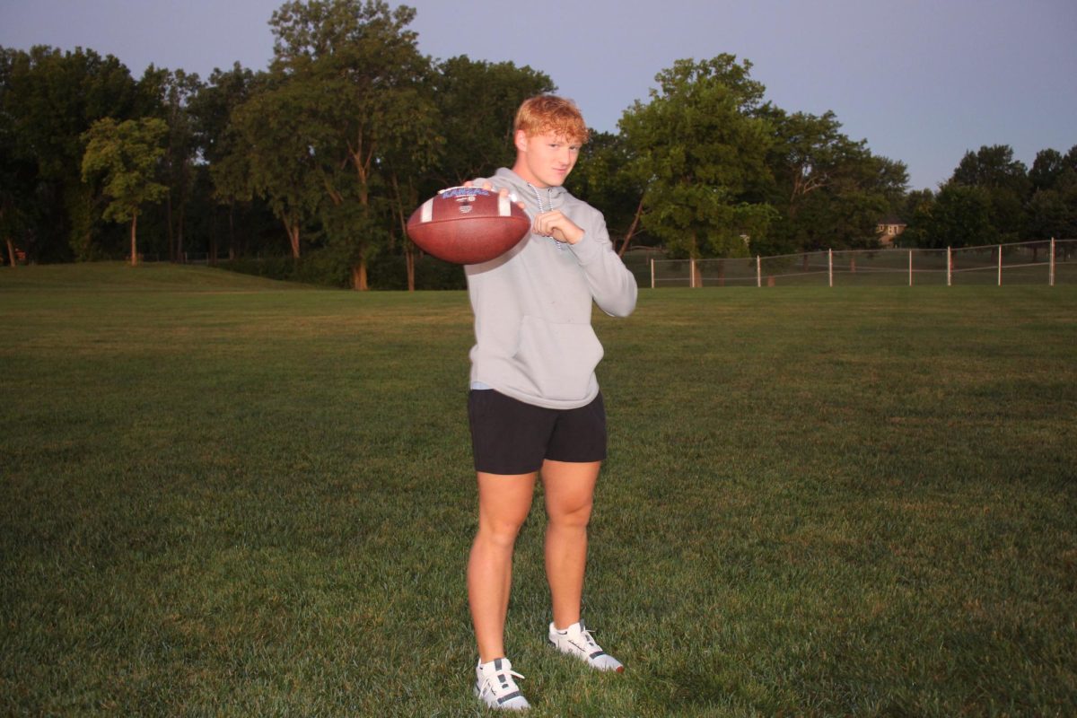 Cade Zimmerman posing with a football.