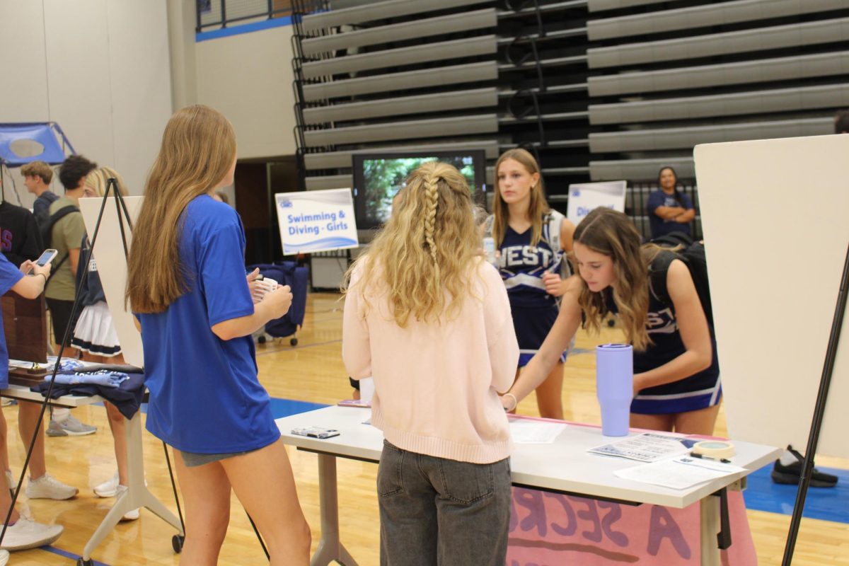 Jodi Garren signing up for FCA at the Activity Fair.