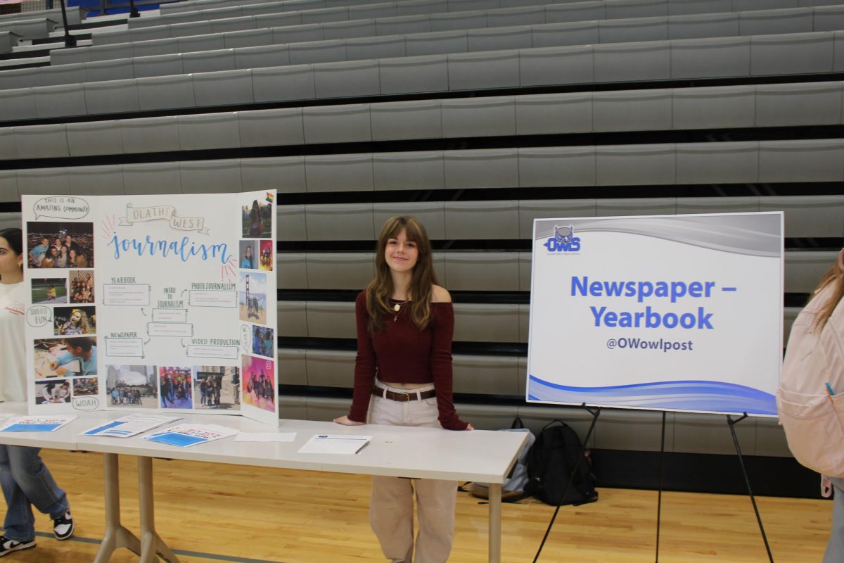Jenna Campbell working the newspaper and yearbook stand during the Activity Fair.
