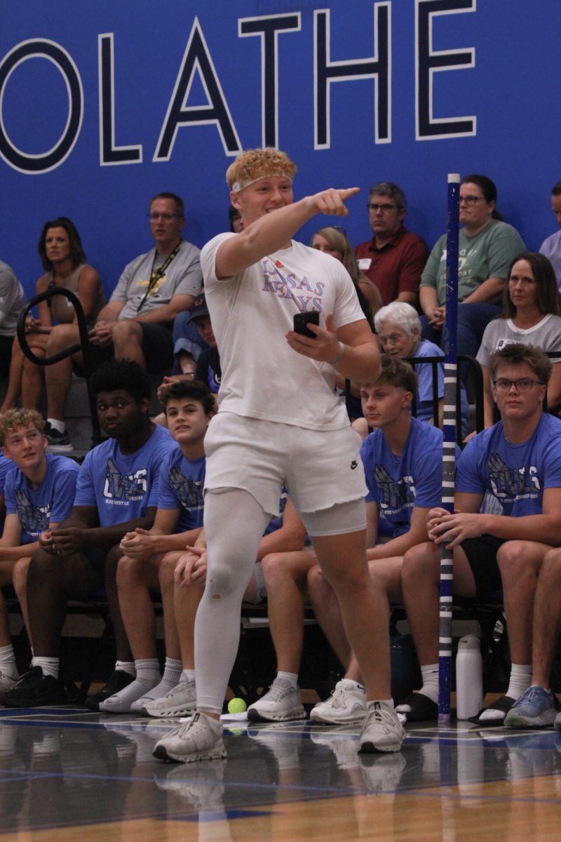 Cade Zimmerman pointing to crowd as they cheer him on.