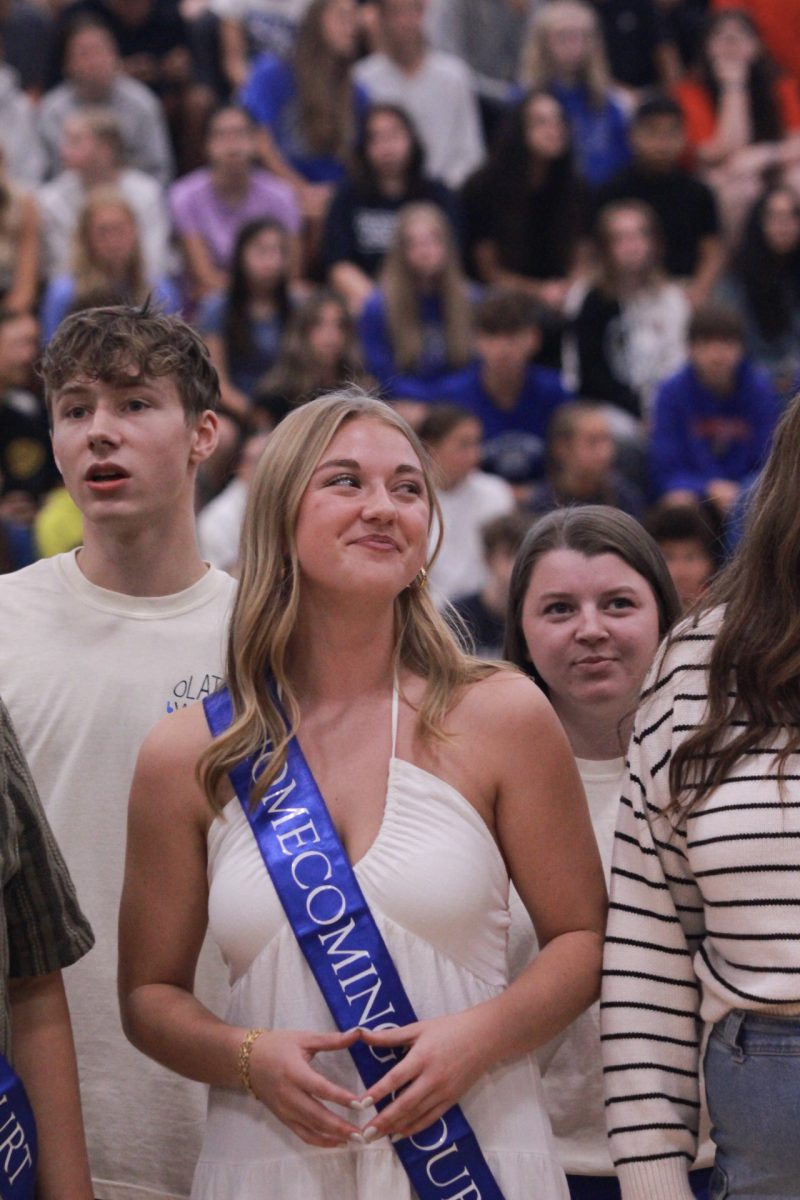 Jared White, Nora Brown, Landry Scholl singing in choir for student section