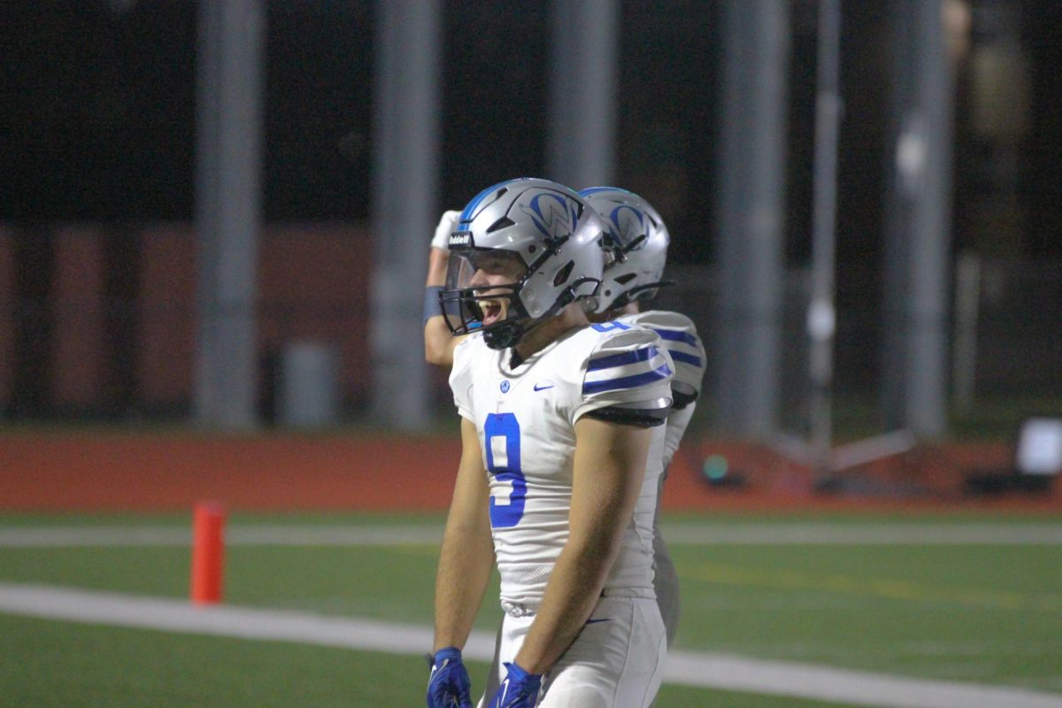 Senior Josh Roland flexes towards the student section vs Shawnee Mission North
