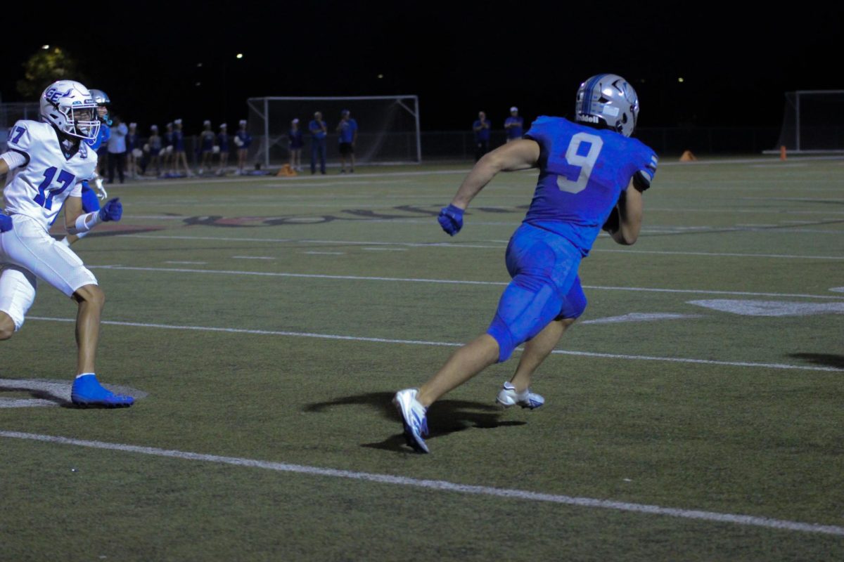 Senior Josh Foland scrambles towards the end zone vs Gardner-Edgerton