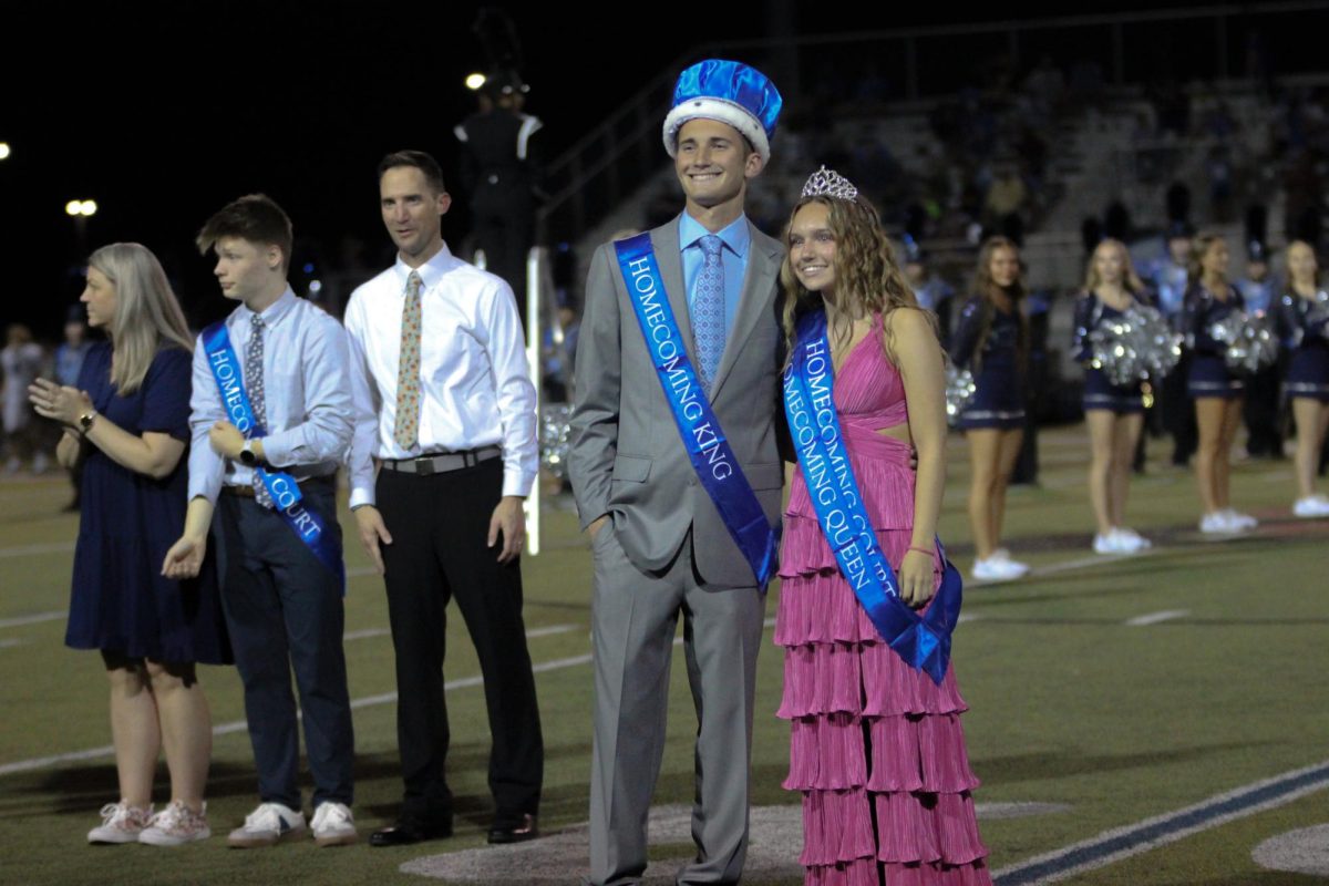 Homecoming royalty Kellen Aldrich and Caitlin Bnags pose during halftime
