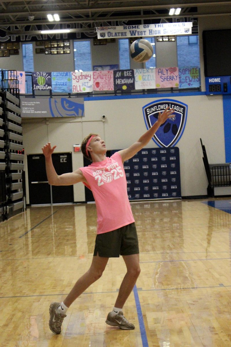 Gunnar Cheney serves the ball.