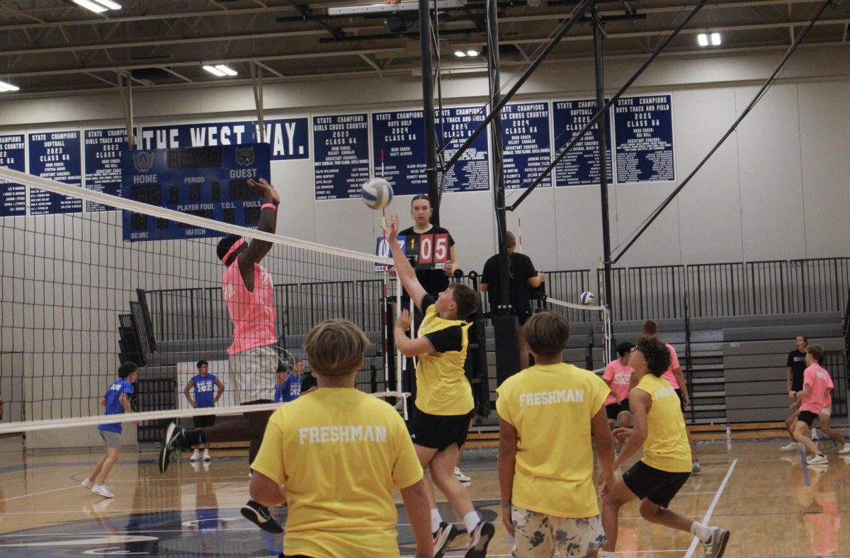 David Harper blocks a hit from the freshman team.