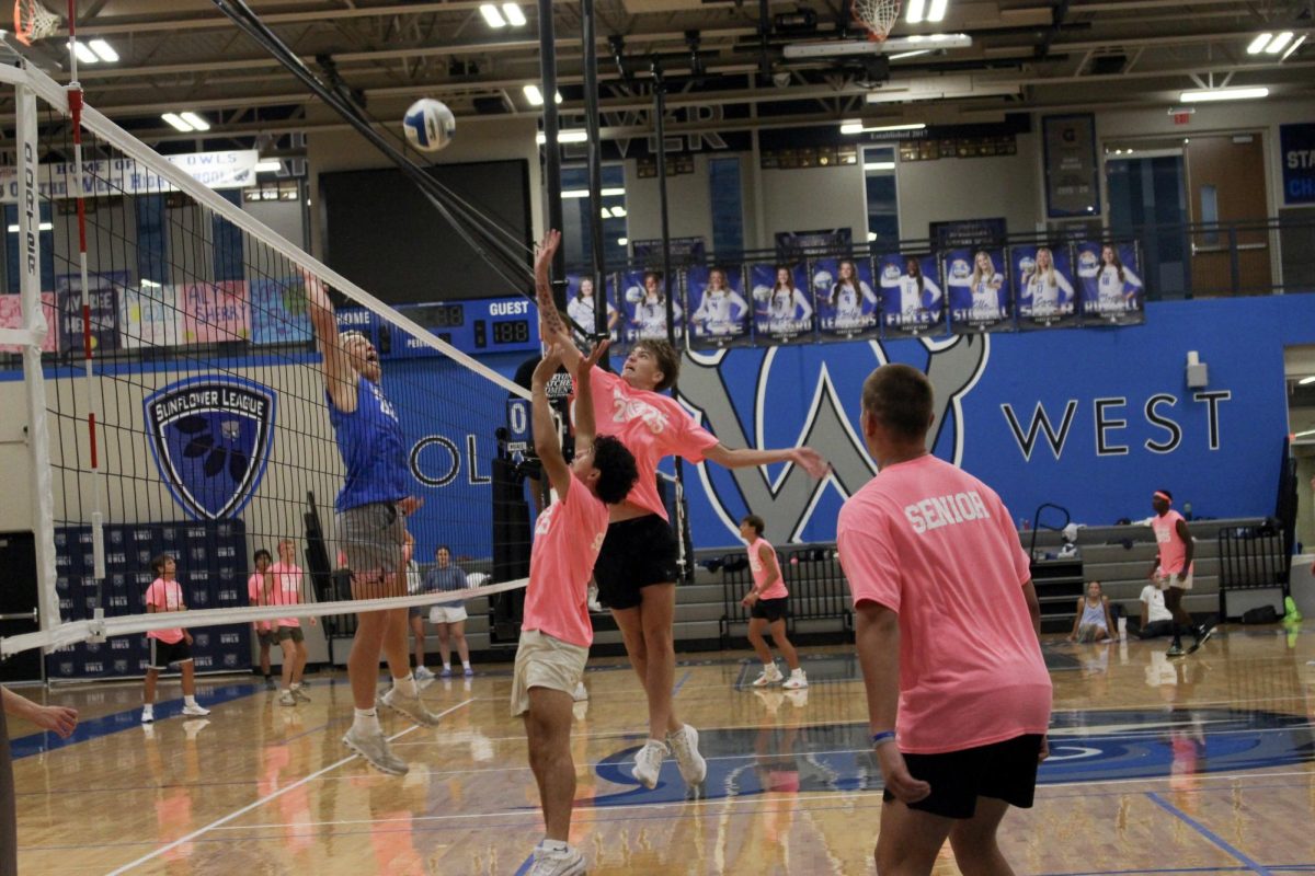 Junior and senior teams are competing for the ball.