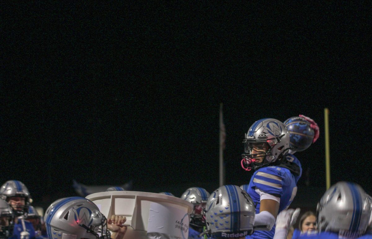 Senior Brody Butler dunks a basketball after an interception vs Olathe South