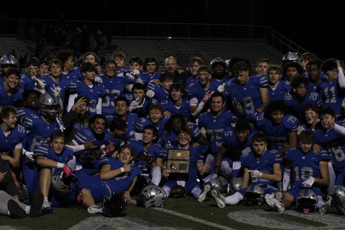 Owls pose with regional trophy after the win vs Olathe South