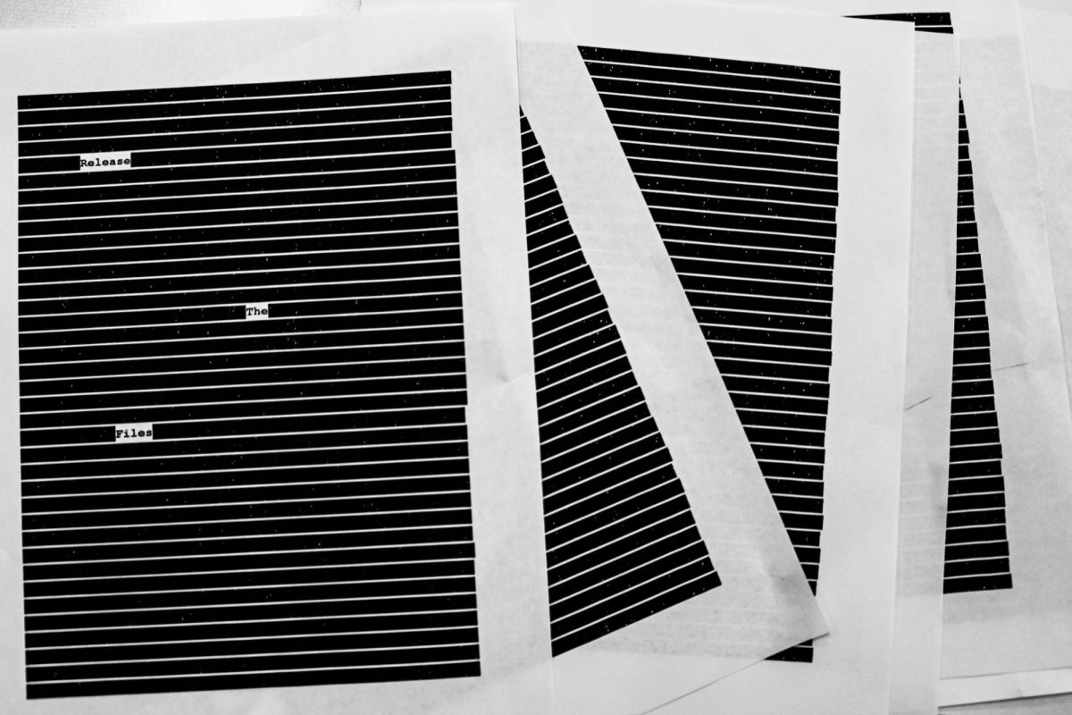Photo depicting redacted documents saying “Release The Files”