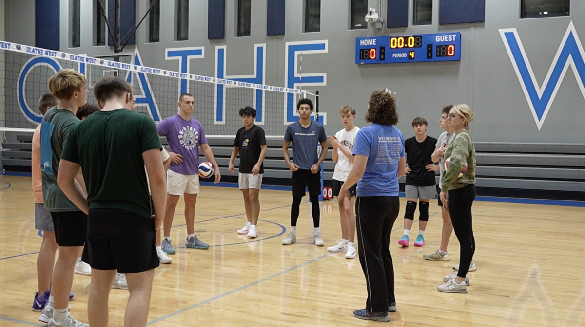 Olathe West boy's volleyball team huddling up at a practice.